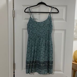 Dark teal spaghetti strap short dress with floral detailing